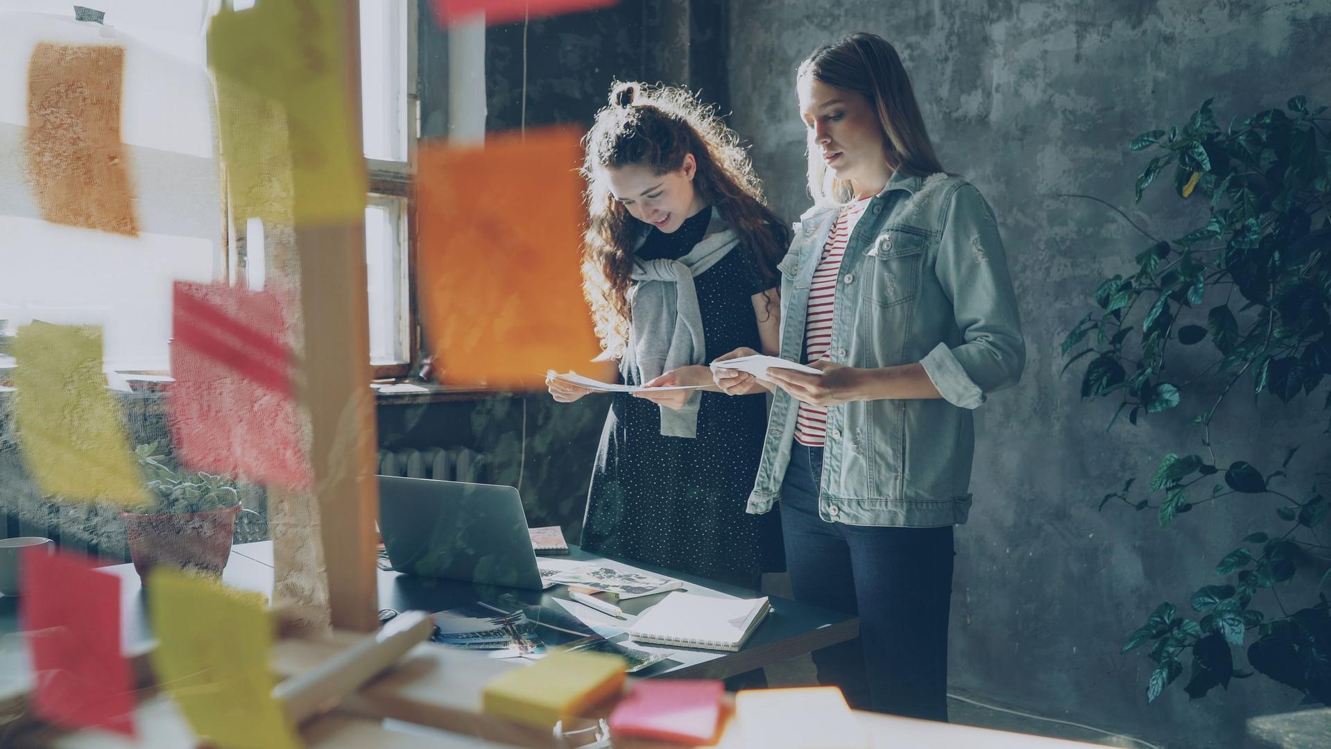 Woman working on laptop with Canva templates